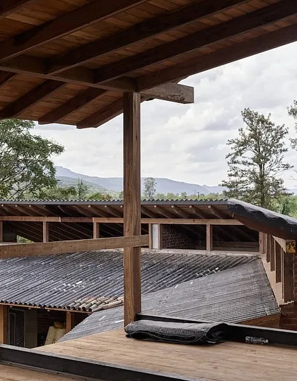 From this upper-level vantage point, you can see the layered roofs and open corridors of the farmhouse. The design creates a complex interplay of solid and void, allowing light and air to move freely through the home.