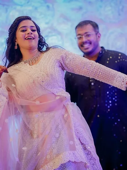The bride takes center stage, dancing with joy and energy during her Sangeet performance. A moment of pure celebration and happiness.