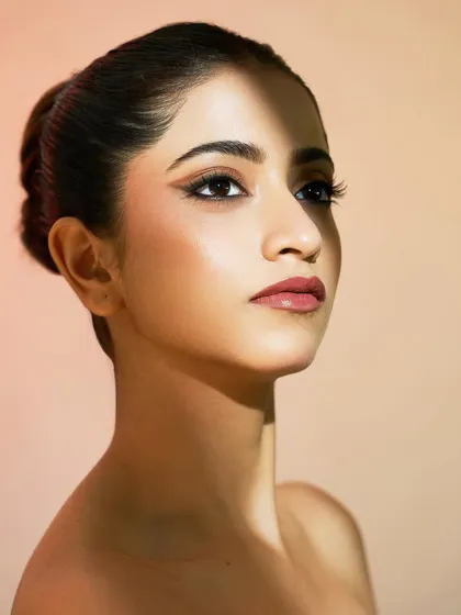 This shot showcases the clean lines of the graphic eyeliner. The rest of the face is kept minimal to let the eyes be the focus.