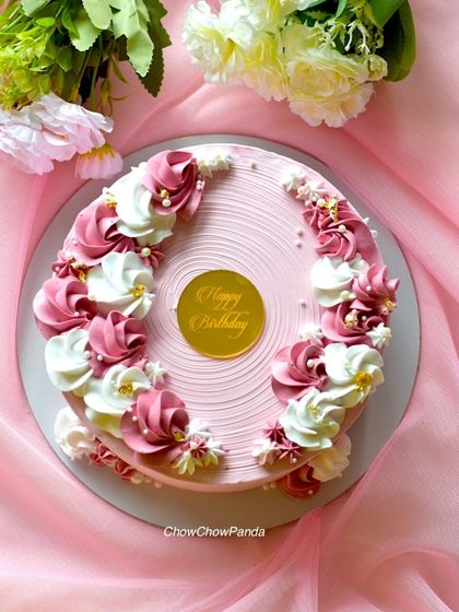A slightly different angle of the floral vanilla cake, highlighting the gold birthday topper.