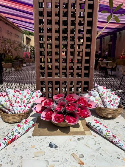 For this pastel Haldi, we prepared cones of fresh rose petals for guests to shower the couple, displayed beautifully in wicker baskets.