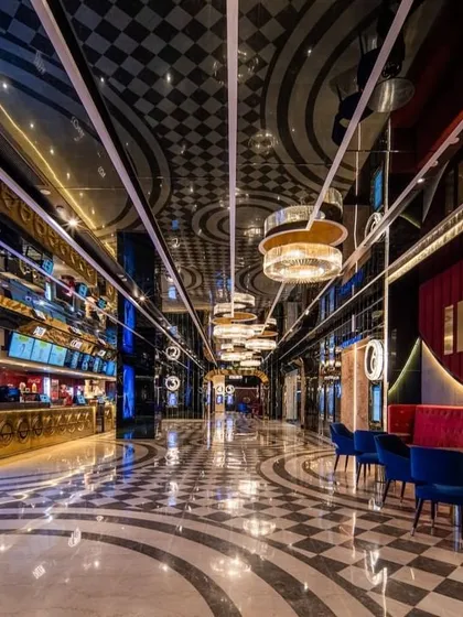 We believe a trip to the cinema should be an event. The foyer at INOX, Rajouri Garden, is designed to build anticipation with its dramatic lighting, reflective surfaces, and bold geometric patterns. The design blends classic Art Deco glamour with modern luxury, creating a memorable passage from the everyday world into the magic of film.