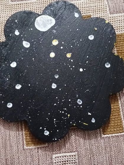 Natanya, a 6-year-old from our Jr. KG batch, created this lovely night sky on a flower-shaped wooden piece. It's a simple yet beautiful craft project that teaches about space and texture.