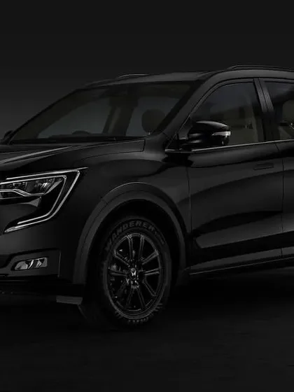 A studio shot of the 2024 Mahindra XUV700 in a striking all-black finish. I used subtle lighting to sculpt the car's form and create a powerful, moody atmosphere.