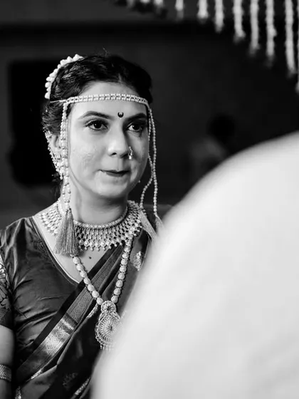 Weddings are an emotional whirlwind. In between the laughter and celebration, there are these quiet, powerful moments of connection. This black and white photo of Poorva during the ceremony captures the profound emotion of the day. These are the honest, heartfelt moments I look for.