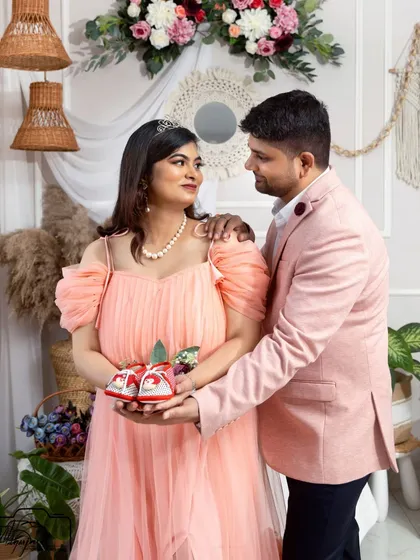 A sweet announcement shot, with the couple holding up tiny baby shoes. A perfect way to share their excitement.
