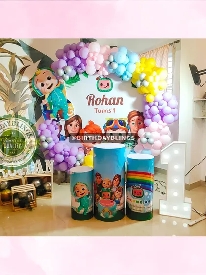 Another angle of the Cocomelon first birthday, showing the full balloon arch and the placement of the JJ cutout.