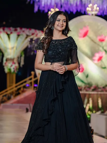 The full view of the reception look, showing how the soft curls balance the dramatic black gown.