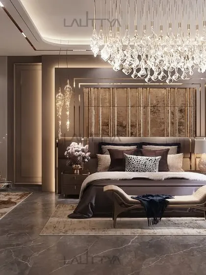 This bedroom design weaves together luxurious textures, rich golden accents, and a soft, inviting glow. The striking chandelier and velvety seating are thoughtfully crafted to enhance both comfort and elegance.