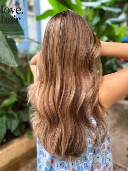 A burnished bronde look. This balayage combines blonde and brown tones for a perfectly blended, multi-dimensional color.