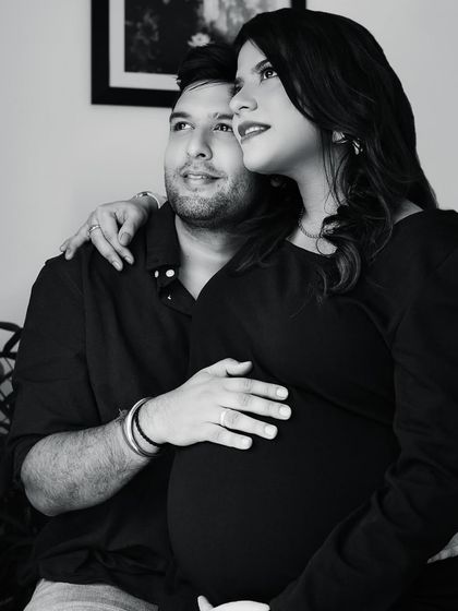 A timeless black and white portrait of an expecting couple looking towards the future together. The classic monochrome style adds a layer of emotion and nostalgia to the moment.