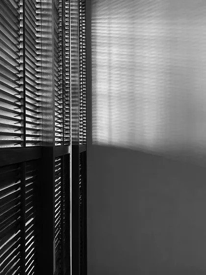 The interplay of light and shadow through wooden blinds in the Worli Duplex. This simple detail creates a beautiful, changing pattern on the walls, adding a sense of dynamism and life to the space.