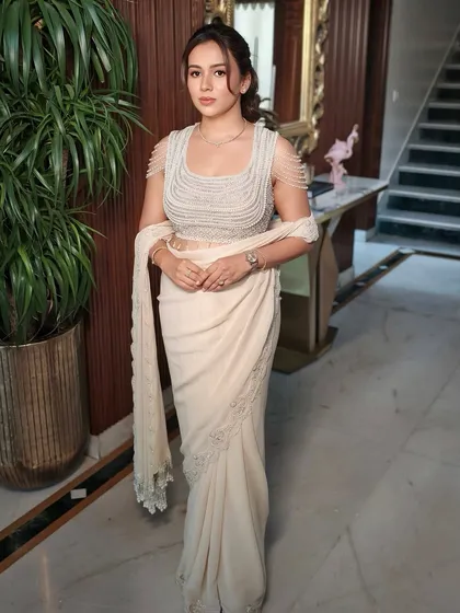 A confident stance showcasing the modern silhouette of the designer outfit.