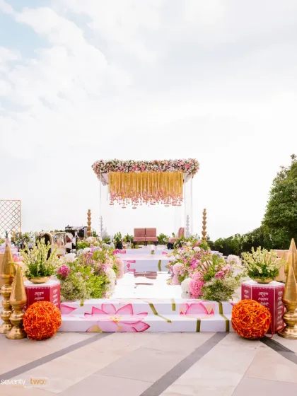 The stunning hilltop mandap in Mahabaleshwar, with its floral canopy and lotus-painted steps, waiting for the couple to begin their forever.
