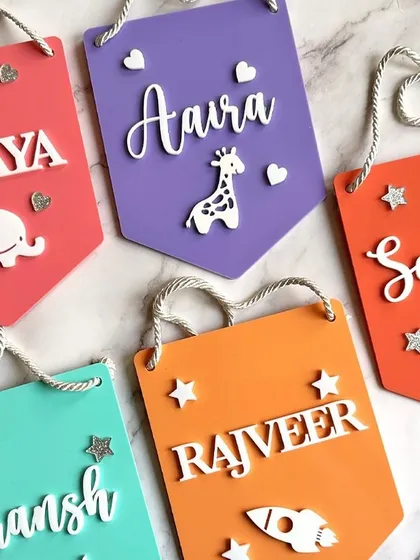 Add a splash of color to your kids' room with our personalised acrylic wall hangers. Choose from various colors and add cute charms like animals or rockets.
