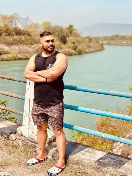 A moment of quiet contemplation by the river in Rishikesh. Nature is the ultimate gym.