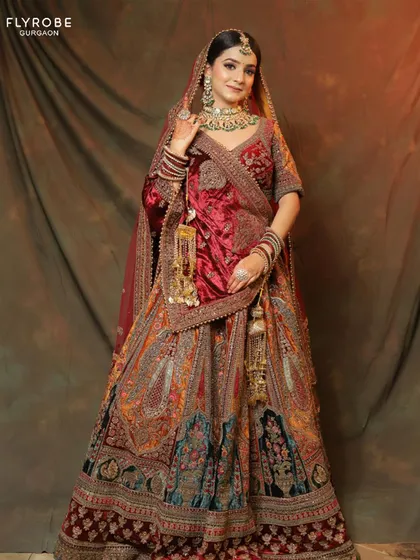 This multi-panelled velvet lehenga with intricate 'doli' motifs is a work of art. It's a heritage piece you can wear for your wedding without the investment.