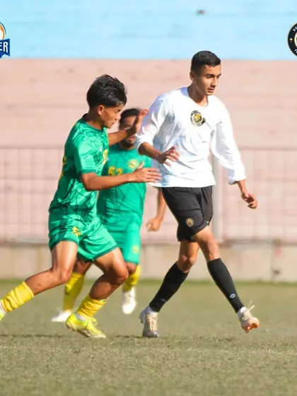 A player calmly controls the ball, looking composed and ready for the next play.