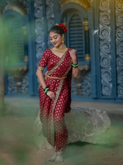 A full-length shot showing the traditional saree drape and styling.