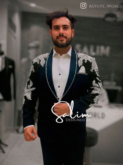 A client wearing the black tuxedo with silver floral embroidery. The shawl lapel and the placement of the embroidery create a very flattering silhouette.