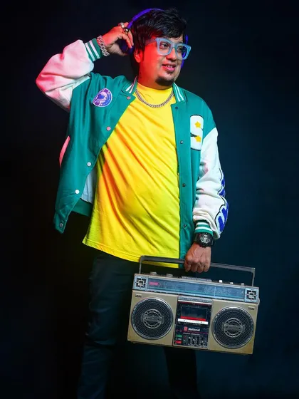 While I stay current, I have an old-school feel. This shot, with a vintage boombox and headphones, represents my love for classic hip-hop beats and the foundational elements of DJ culture.