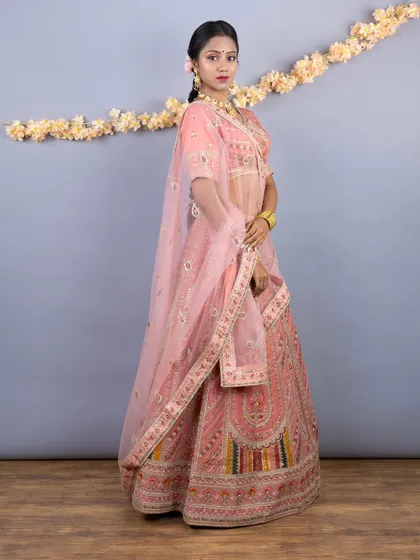 Another beautiful shot of the peach lehenga, showing the full flare of the skirt and the delicate, sheer dupatta.