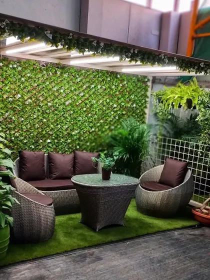 We also showcase how to create comfortable outdoor or balcony seating areas. Here you can see our range of garden furniture set against an artificial green wall, perfect for urban living.