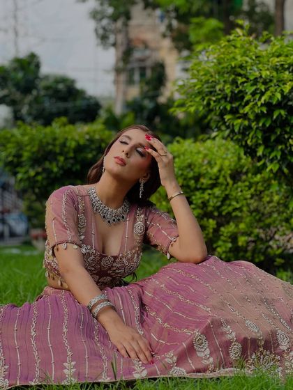 A close-up of the mauve lehenga, paired with a stunning diamond necklace. We also offer jewelry on rent to complete your look.