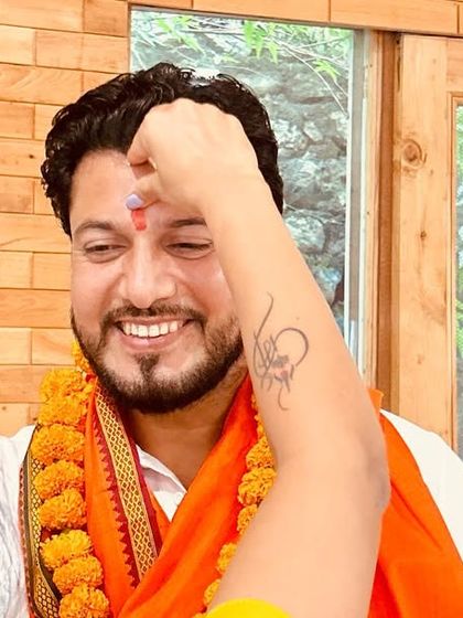 The traditional tilak ceremony, marking an auspicious moment as a student completes their journey to become a certified yoga teacher.