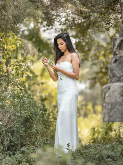 A duplicate of image 26, this dreamy, editorial bridal shoot in a lush, green forest has a fairytale-like quality.