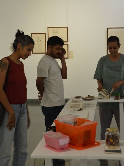 Visitors engaging with the artist's collection of objects, which were central to the narrative of 'Bring me Flowers'.