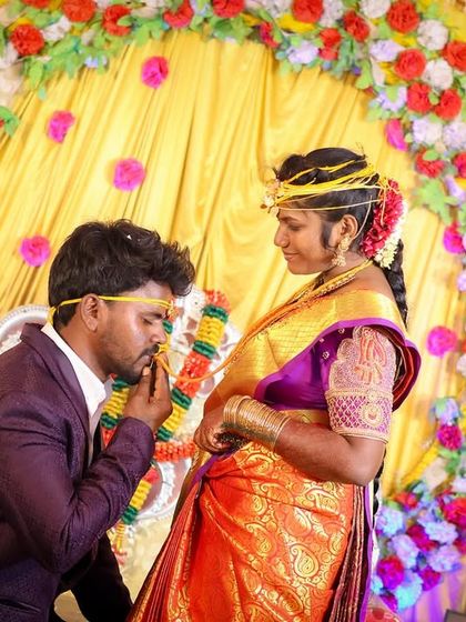 A tender moment between the bride and groom on stage. His gentle gesture and her calm expression make for a beautiful, romantic photograph that highlights their bond.