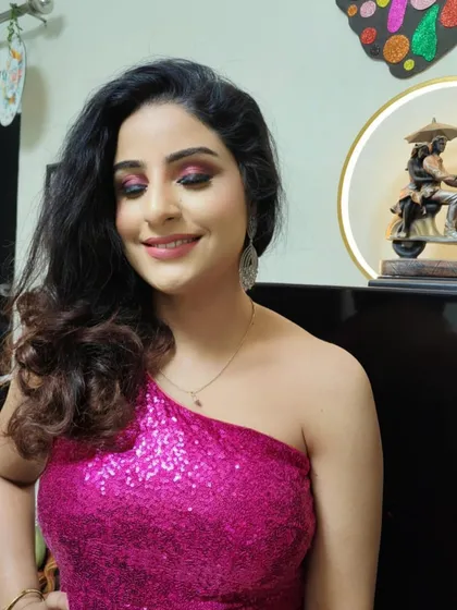 A happy smile completes this party-ready look. The pink smokey eye and glowing skin make her look and feel absolutely radiant.