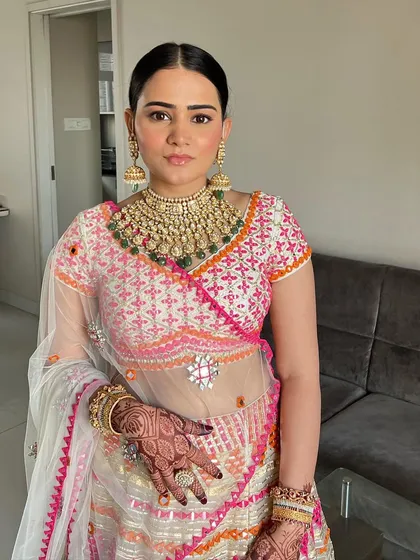 A direct look at this blushed beauty. The makeup is soft and fresh, enhancing her natural features and complementing the colourful lehenga.