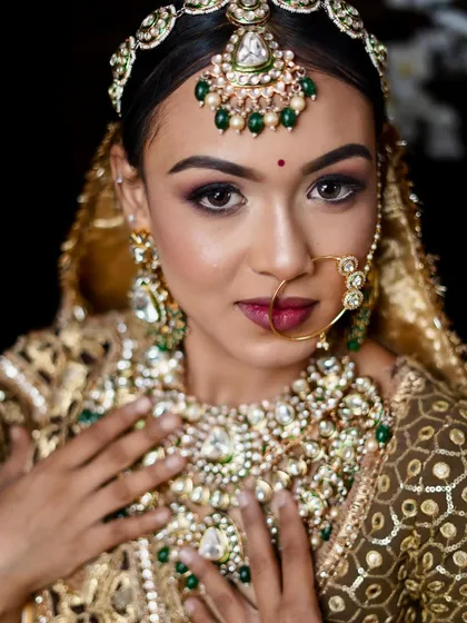 A stunning ethnic bridal look with a focus on dramatic, smoky eyes and heavy, traditional jewelry.