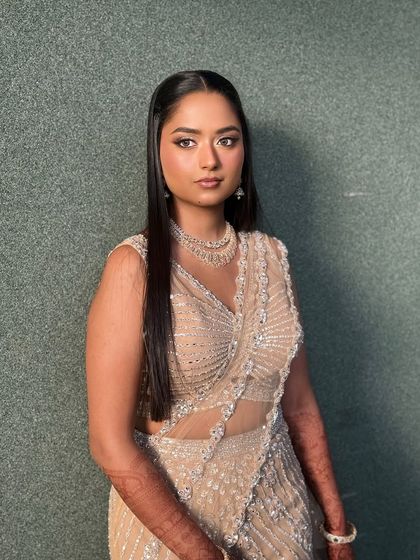 A portrait shot showing the intricate details of her lehenga and her flawless makeup.