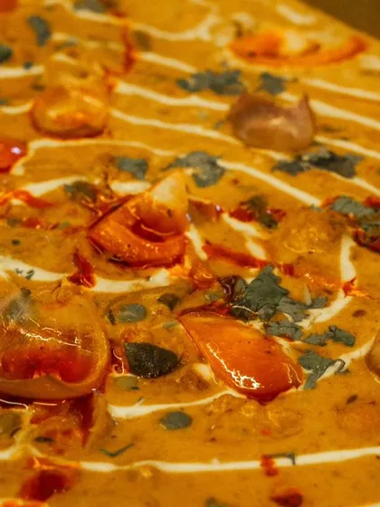 A close-up of a rich and creamy paneer dish, one of the many mouth-watering options available for your team.