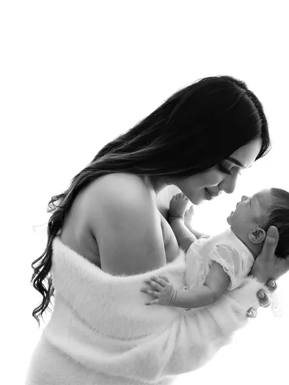 A new mother looking at her baby with pure love. Black and white photography strips away distractions and focuses on the emotion of the moment.
