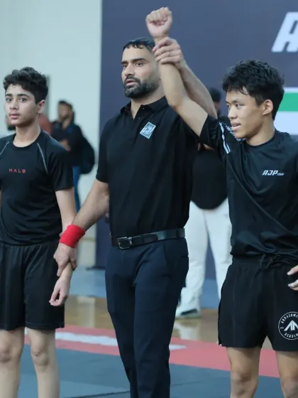 Raising the hand of a winner. As a referee, I get a front-row seat to the incredible skill and heart these young competitors bring to the mat.