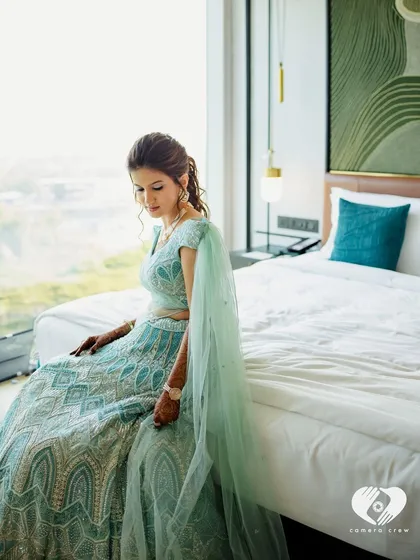 A fairytale moment. The bride's pastel blue gown and soft, glowing makeup create a magical and dreamy look.