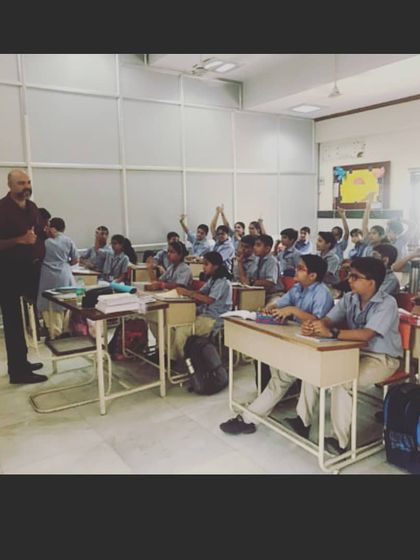 This is a typical classroom session where students are actively engaged in a discussion. I encourage a collaborative environment where children learn from me and from each other, building both their language skills and their ability to work in a team.