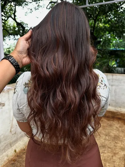 Getting ready for 'Ghar ki shaadi' (a home wedding). This client wanted a glamorous but natural look, so I gave her a rich color melt with soft waves, perfect for the occasion.