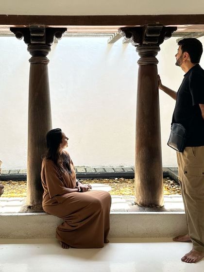 A moment of quiet contemplation in a space inspired by traditional architecture, featuring antique pillars and an open-air courtyard. These elements connect us to the past and ground the home in a sense of place.