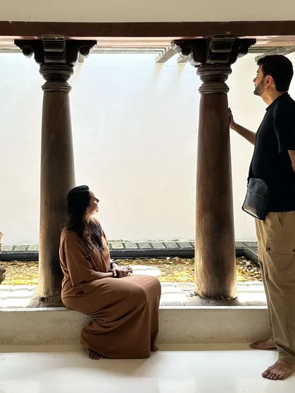 A moment of quiet contemplation in a space inspired by traditional architecture, featuring antique pillars and an open-air courtyard. These elements connect us to the past and ground the home in a sense of place.