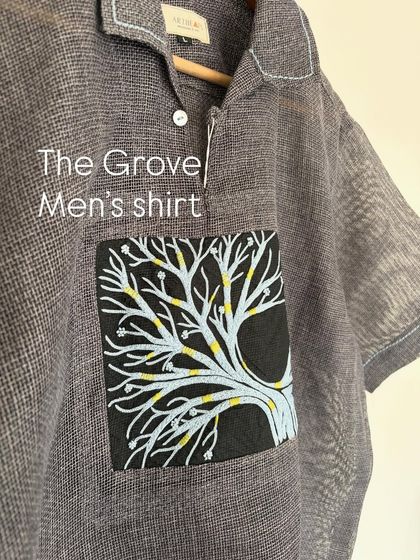 The Grove Men's Shirt, featuring a hand-drawn tree of life design on the pocket. This piece combines textured handloom cotton with detailed artwork.