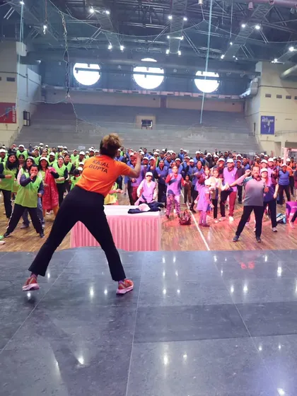 A wide shot of the huge indoor stadium during our Zumba session for a corporate marathon. The scale was incredible.