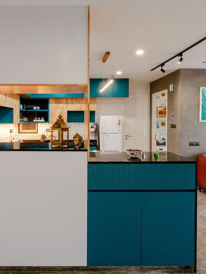 The kitchen is seamlessly integrated with the living area, with a pass-through window that keeps the spaces connected.