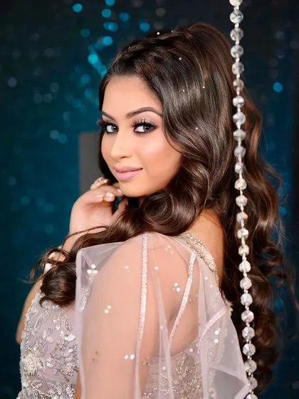 A glamorous sangeet or reception look featuring a lavender gown. The jewellery is modern and chic, with a diamond necklace and delicate hair accessories.