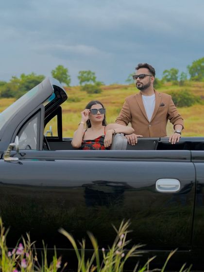 The couple enjoying a ride in a classic Cadillac convertible through the green landscapes of Goa. This is a perfect shot for a vintage-themed pre-wedding shoot.
