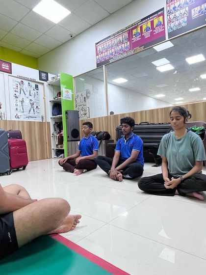 A meditation session led by one of our senior shooters, helping the team relax and mentally reset after training.
